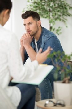 therapist talking to sombre man