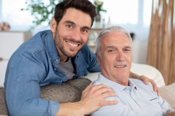 excited man with elderly father talking enjoying leisure time