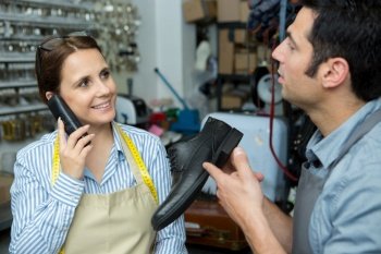 female shoemaker on the phone talking to customer