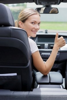 woman giving thumbs up in the car