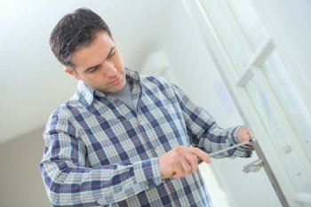 Man screwing on door handle