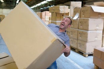 mover guy carrying a heavy box and falling