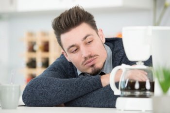 a man waiting for coffee to be made