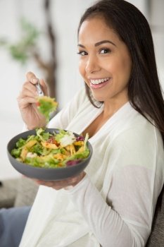 beautiful woman eating a healthy salad