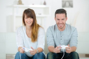 happy couple using a joystick