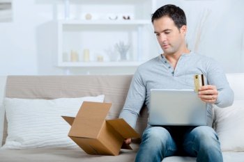 man in house buying online