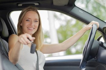 happy woman driver showing car key