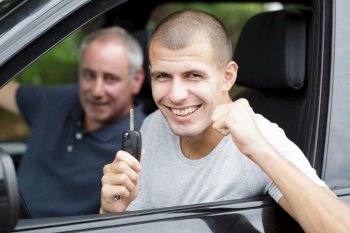 man holding the keys of a new car