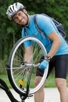 male cyclist fixing a bicycle