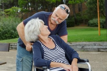 man and senior woman in a wheelchair