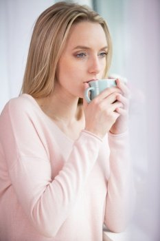 portrait of cute woman drinking coffee