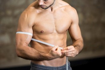 picture of man measuring his arm muscle