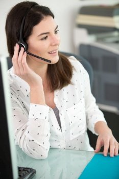 beautiful consultant of call center wearing headphones