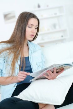 a young woman reading a magazine