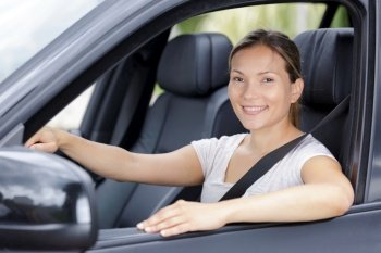 beautiful young happy woman in car
