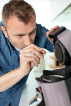 professional worker fixing coffee machine