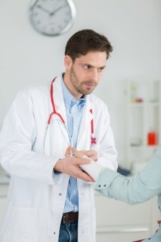portrait of pretty male doctor giving first aid to patient