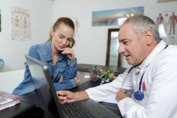senior man doctor patient laptop computer