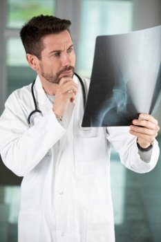concerned doctor looking at radiography