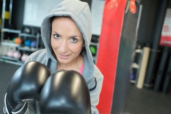 Portrait of woman wearing boxing gloves