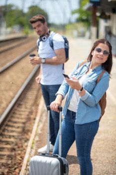 tourists traveler consulting guide from smart phone in train station