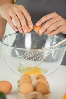 woman separating the yolk from the egg white in closeup