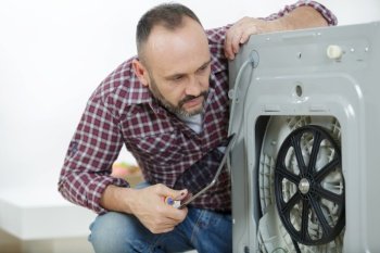 professional worker estimating cost for broken washing machine