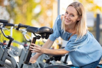 young woman posing in a parking lot with bicycles