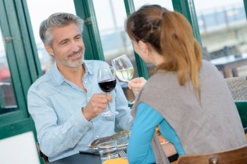 Man and woman toasting with wine