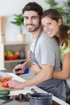 portrait of a cheerful young couple cooking together