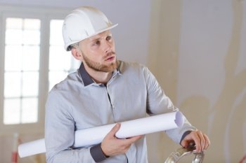 man holding a paper in construction site