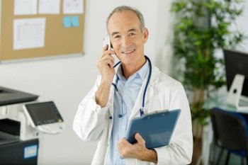 portrait of senior male doctor on the telephone