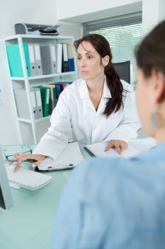 female doctor talking with patient in office