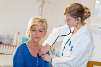 nurse is counting heart rate of a female patient