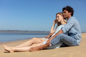 happy couple siting on beach romantic man and woman