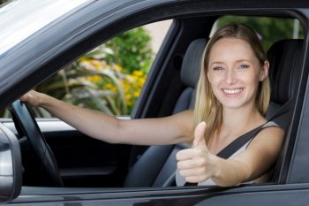 pretty smiling girl driving a car
