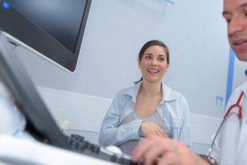 happy preganant woman visiting obstetrician
