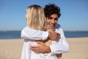 loving young couple hugging on the beach