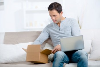 entrepreneur opening a parcel at home