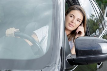 woman is distracted on the phone while driving