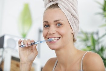happy woman brushing her teeth