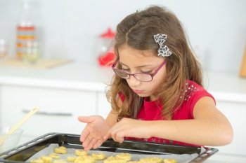 a young girl is baking a cake