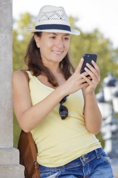 portrait of attractive smiling woman using her mobile phone