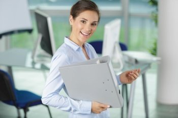 elegant corporate businesswoman with folder in hands