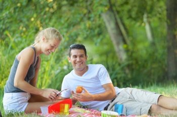 couple having picnic man holding apple
