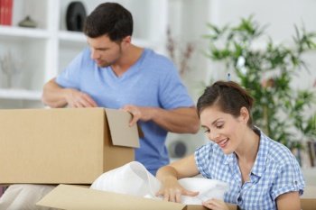 couple unpacking boxes with property housewarming