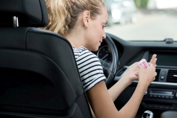 woman taking medication while driving