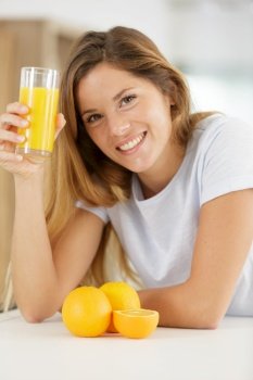 beautiful young woman with glass of orange juice