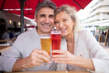 mature couple having a drink outdoors