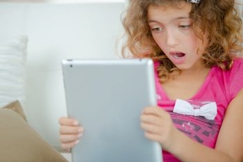a girls holding a tablet is shocked